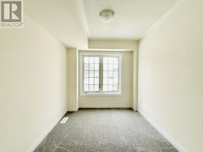 Pickering townhouse for rent - A room with a window and carpeted floor.