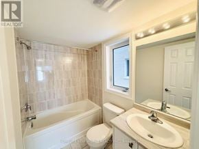 Pickering townhouse for rent - A bathroom with a tub, toilet, and sink.