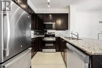 Toronto (Don Valley Village) condo for rent - A modern kitchen with dark brown cabinets and stainless steel appliances.