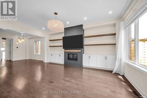 Aurora (Aurora Estates) apartment for rent - A spacious living room with a fireplace and a flat screen TV mounted on the wall.