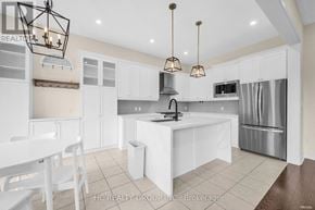 Aurora (Aurora Estates) apartment for rent - A modern kitchen with white cabinets and a central island.