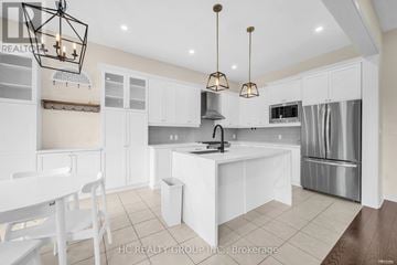 Aurora (Aurora Estates) apartment for rent - A modern kitchen with white cabinets and a central island.