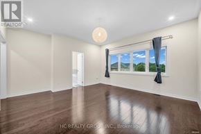 Aurora (Aurora Estates) apartment for rent - A spacious room with a large window and wooden flooring.