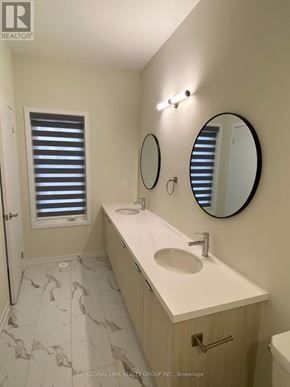 Richmond Hill townhouse for rent - A bathroom with a sink, mirror, and a window with blinds.