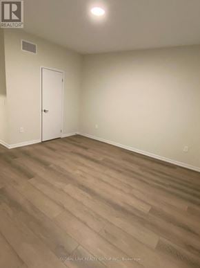 Richmond Hill townhouse for rent - A room with a white door and wooden flooring.