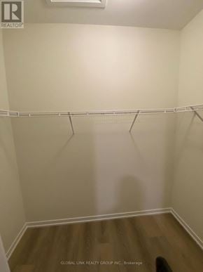 Richmond Hill townhouse for rent - A white closet with a wooden floor and a white shelf.