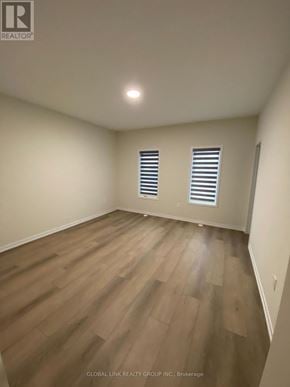 Richmond Hill townhouse for rent - A room with wooden flooring and two windows with blinds.