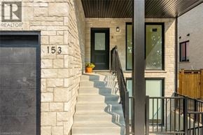Rockwood apartment for rent - A stone building with a black door and a number 153 on it.
