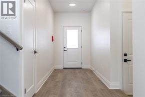 Rockwood apartment for rent - A hallway with a white door and a staircase on the left.