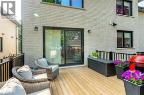 Rockwood apartment for rent - A patio with a wicker chair and a table with a red grill.