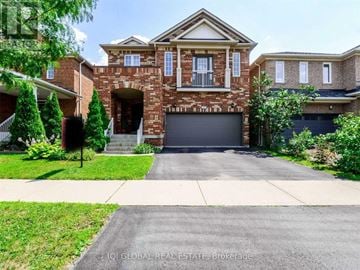 Milton (De Dempsey) apartment for rent - A large house with a brick facade and a garage door.