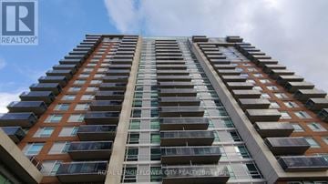 Brampton (Queen Street Corridor) condo for rent - A tall building with a sign that says "Royal LePage Flower City Realty Brokerage".
