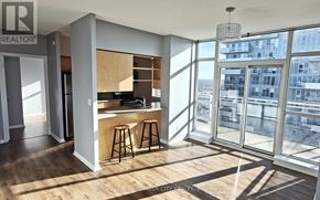 Brampton (Queen Street Corridor) condo for rent - A modern kitchen with wooden floors and a bar area.