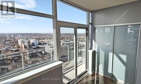 Brampton (Queen Street Corridor) condo for rent - A room with a view of the cityscape from a large window.