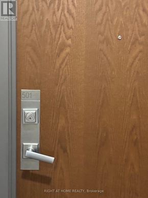 Mississauga (City Centre) condo for rent - A door with a silver handle and a lock on it.