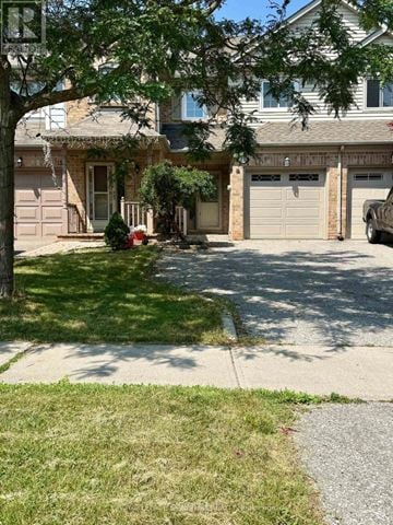 Oakville (Wt West Oak Trails) townhouse for rent - A house with a tree in front of it.