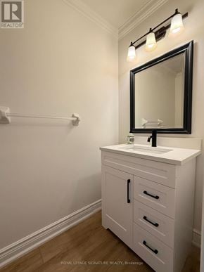 Oakville (Wt West Oak Trails) townhouse for rent - A white bathroom vanity with a black framed mirror and lights above it.