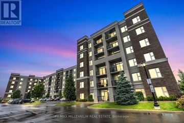 Milton (Wi Willmott) condo for rent - A large apartment complex with a parking lot in front.