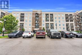 Milton (Wi Willmott) condo for rent - A parking lot with cars and a building in the background.