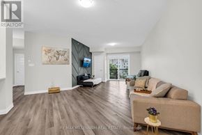 Milton (Wi Willmott) condo for rent - A spacious living room with a couch, a chair, and a coffee table.