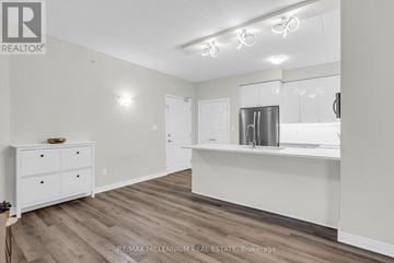 Milton (Wi Willmott) condo for rent - A kitchen with white cabinets and a wooden floor.