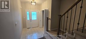 Kingston (City Northwest) townhouse for rent - A hallway with a staircase and a door with a glass window.