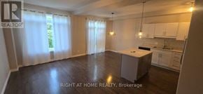 Kingston (City Northwest) townhouse for rent - A spacious room with a kitchenette and a dining area.