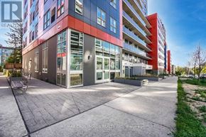 Waterloo condo for rent - A modern multi-story building with a glass facade and a red stripe on the side.