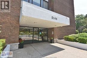 Windsor condo for rent - The entrance to a building with a sign that reads "REALTOR" and the number 2144.