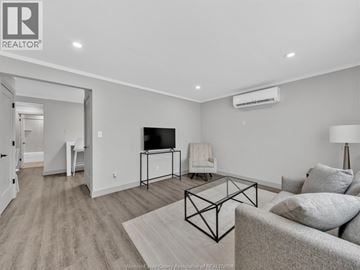Windsor apartment for rent - A living room with a grey couch and a black metal coffee table.