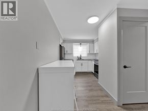 Windsor apartment for rent - A kitchen with white cabinets and a white door.