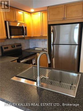 Toronto (Willowdale East) condo for rent - A kitchen with a stainless steel refrigerator and microwave.