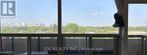 Toronto (Bayview Woods-Steeles) condo for rent - A window with a view of a city skyline and trees.