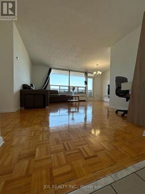Toronto (Bayview Woods-Steeles) condo for rent - A spacious living room with wooden flooring and a large window.
