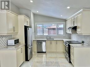 Toronto (Woburn) apartment for rent - A kitchen with white cabinets and a black refrigerator.