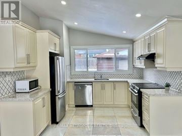 Toronto (Woburn) apartment for rent - A kitchen with white cabinets and a black refrigerator.