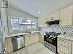 Toronto (Woburn) apartment for rent - A kitchen with white cabinets and a black stove top oven.
