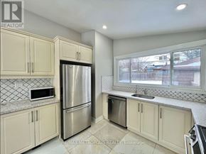 Toronto (Woburn) apartment for rent - A kitchen with a refrigerator, microwave, and oven.