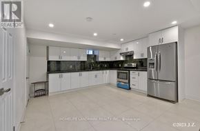Vaughan (Kleinburg) apartment for rent - A modern kitchen with white cabinets and stainless steel appliances.