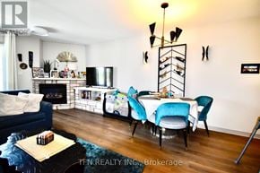 Oro-Medonte (Horseshoe Valley) condo for rent - A living room with a blue couch, a white table, and a fireplace.