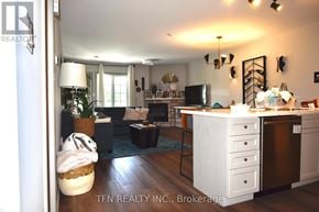 Oro-Medonte (Horseshoe Valley) condo for rent - A well-lit living room with a couch, coffee table, and a television.