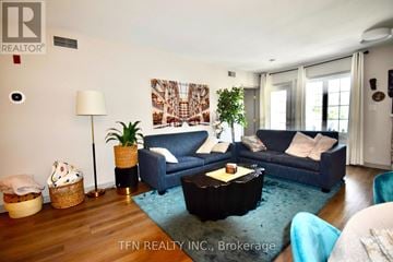 Oro-Medonte (Horseshoe Valley) condo for rent - A living room with a blue couch and a wooden floor.