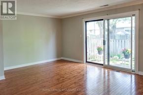 Mississauga (Streetsville) townhouse for rent - A room with wooden floors and a sliding glass door leading to a patio.