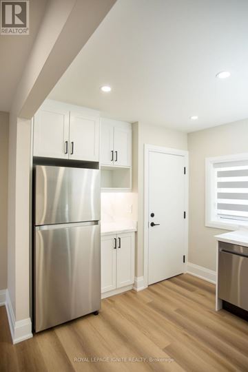 Toronto (Downsview-Roding-Cfb) apartment for rent - A kitchen with a stainless steel refrigerator and wooden floors.