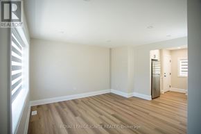 Toronto (Downsview-Roding-Cfb) apartment for rent - A room with wooden floors and white walls, with a door on the right side.
