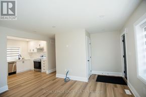 Toronto (Downsview-Roding-Cfb) apartment for rent - A well-lit, empty room with wooden floors and white walls.
