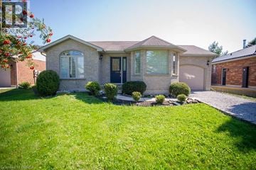Port Dover apartment for rent - A house with a well-maintained lawn and a clear sky.