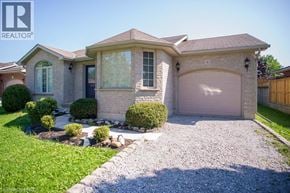 Port Dover apartment for rent - A house with a gravel driveway and a garage door.