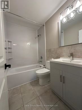 Mississauga (Cooksville) condo for rent - A bathroom with a white toilet, sink, and bathtub.