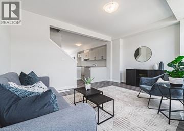 Cambridge townhouse for rent - A living room with a grey couch, a black coffee table, and a grey armchair.